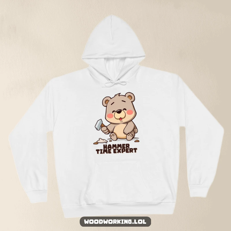 Funny hoodie showing a determined cartoon bear cheerfully hammering a crooked nail, perfect for DIY enthusiasts.