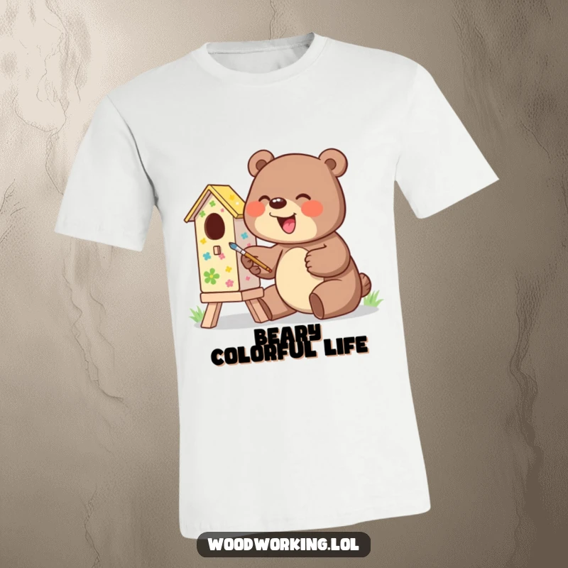 Funny t-shirt of a giggling bear enthusiastically painting a colorful birdhouse, ideal for art lovers.